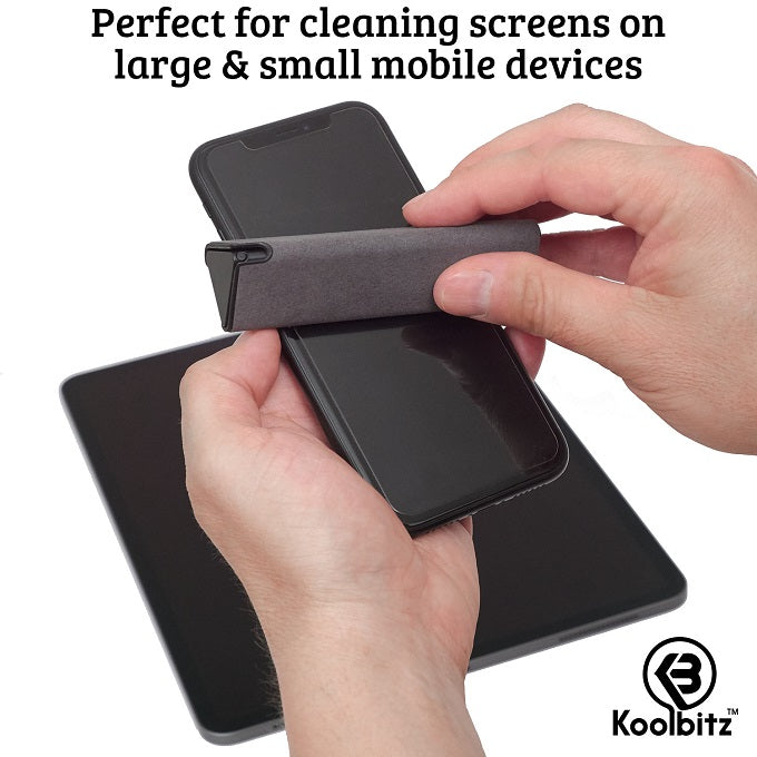 man holding phone while using grey screen cleaner to wipe the screen. Tablet screen sitting on table under man's hands.